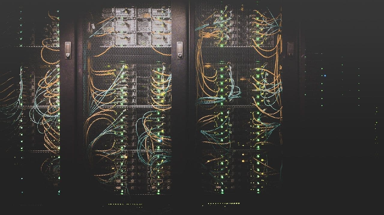 Server room with glowing cables and network infrastructure — the same systems that protect against external threats also govern insider risk